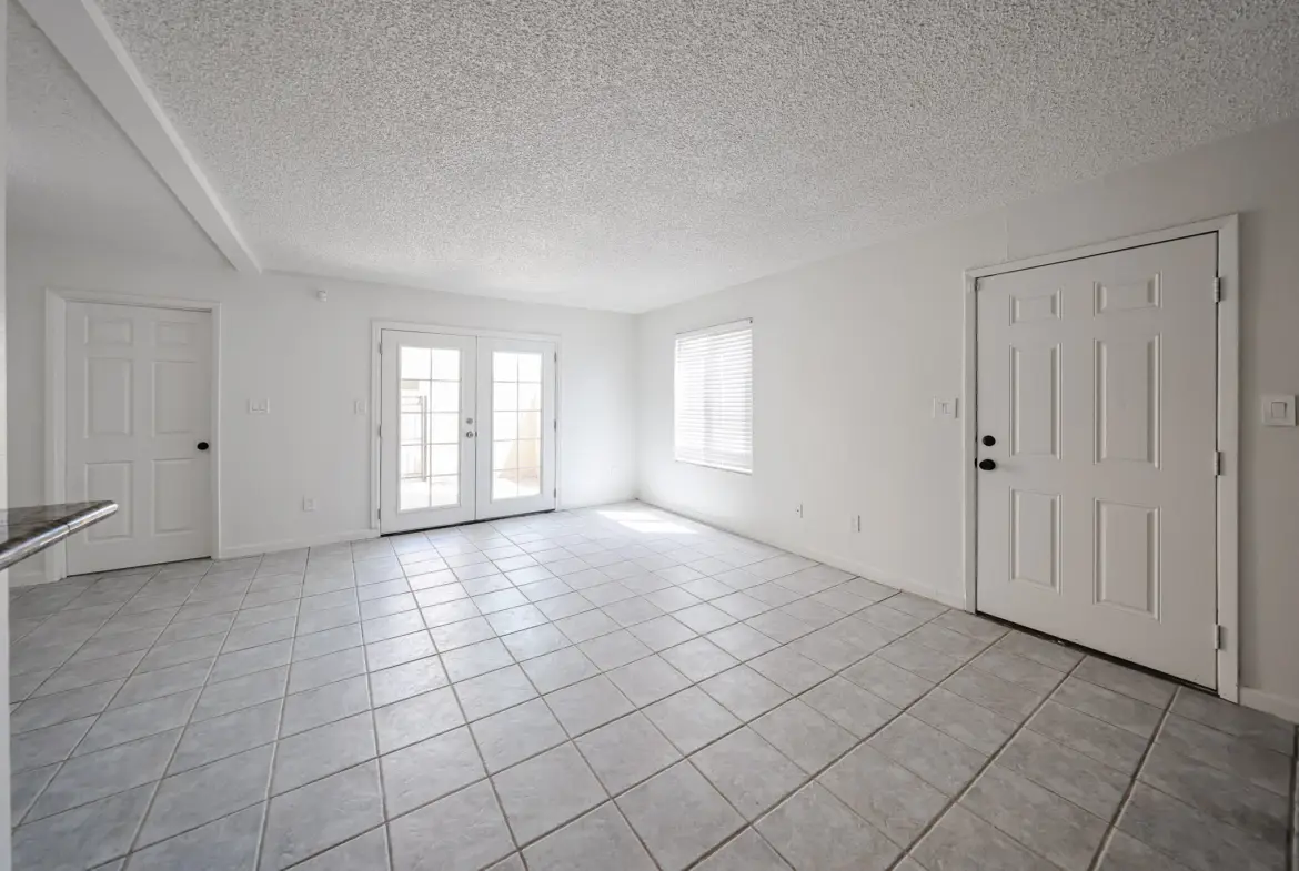 Living room with windows and tile flooring