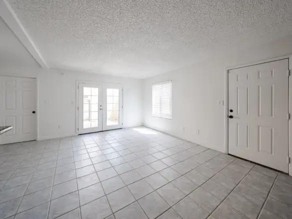 Living room with windows and tile flooring