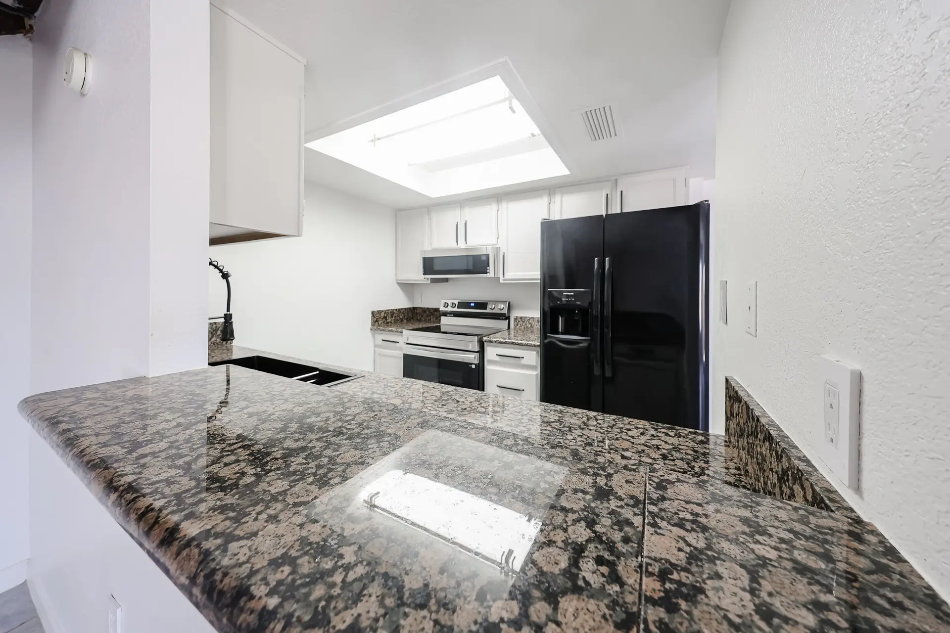 Granite Breakfast Bar Granite breakfast bar in the updated kitchen