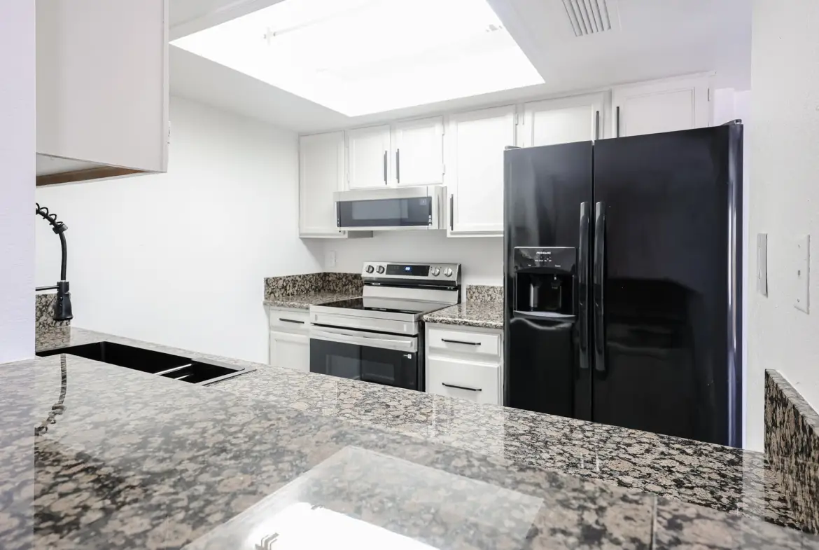 Kitchen opening to the living area at 17032 N 16th Dr Unit 7