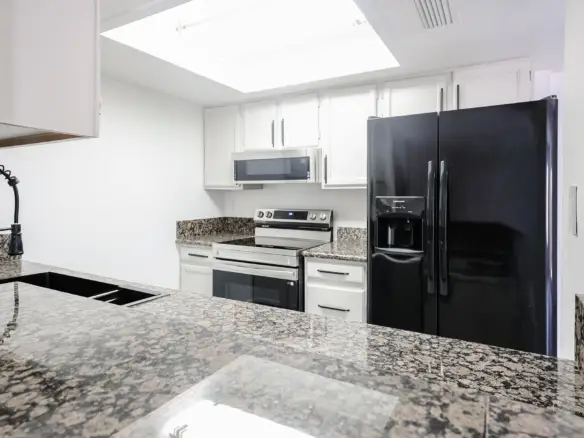 Kitchen opening to the living area at 17032 N 16th Dr Unit 7