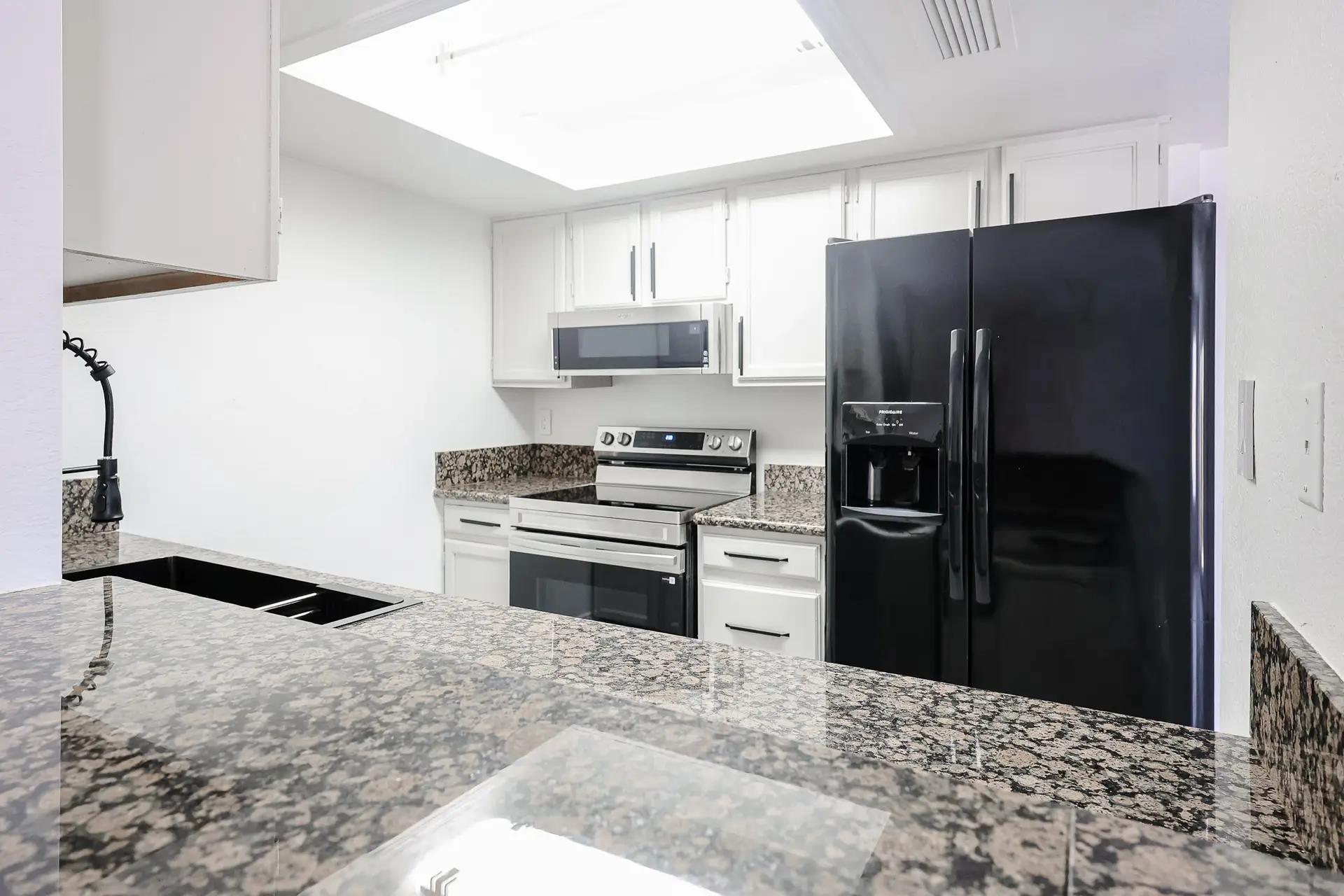 Kitchen and Living Area Kitchen opening to the living area at 17032 N 16th Dr Unit 7