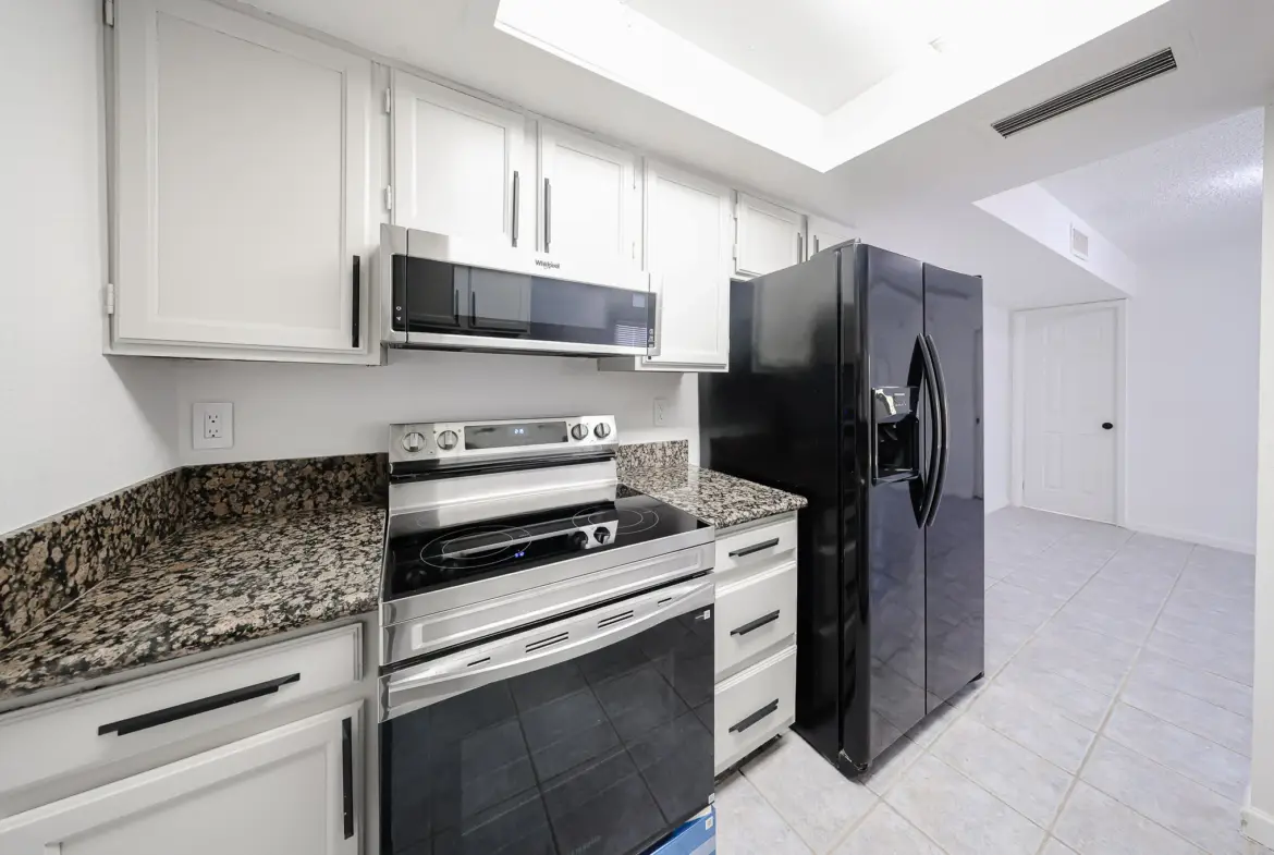Updated kitchen with refrigerator, range and microwave