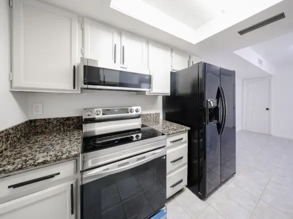 Updated kitchen with refrigerator, range and microwave