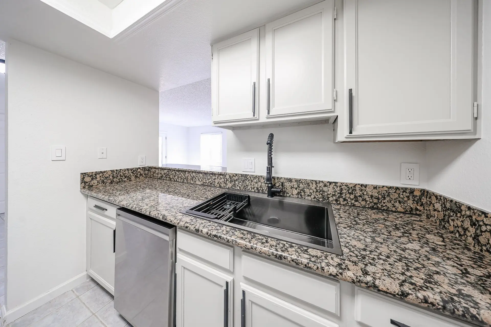 Granite Countertops Granite countertops and white cabinets in the kitchen