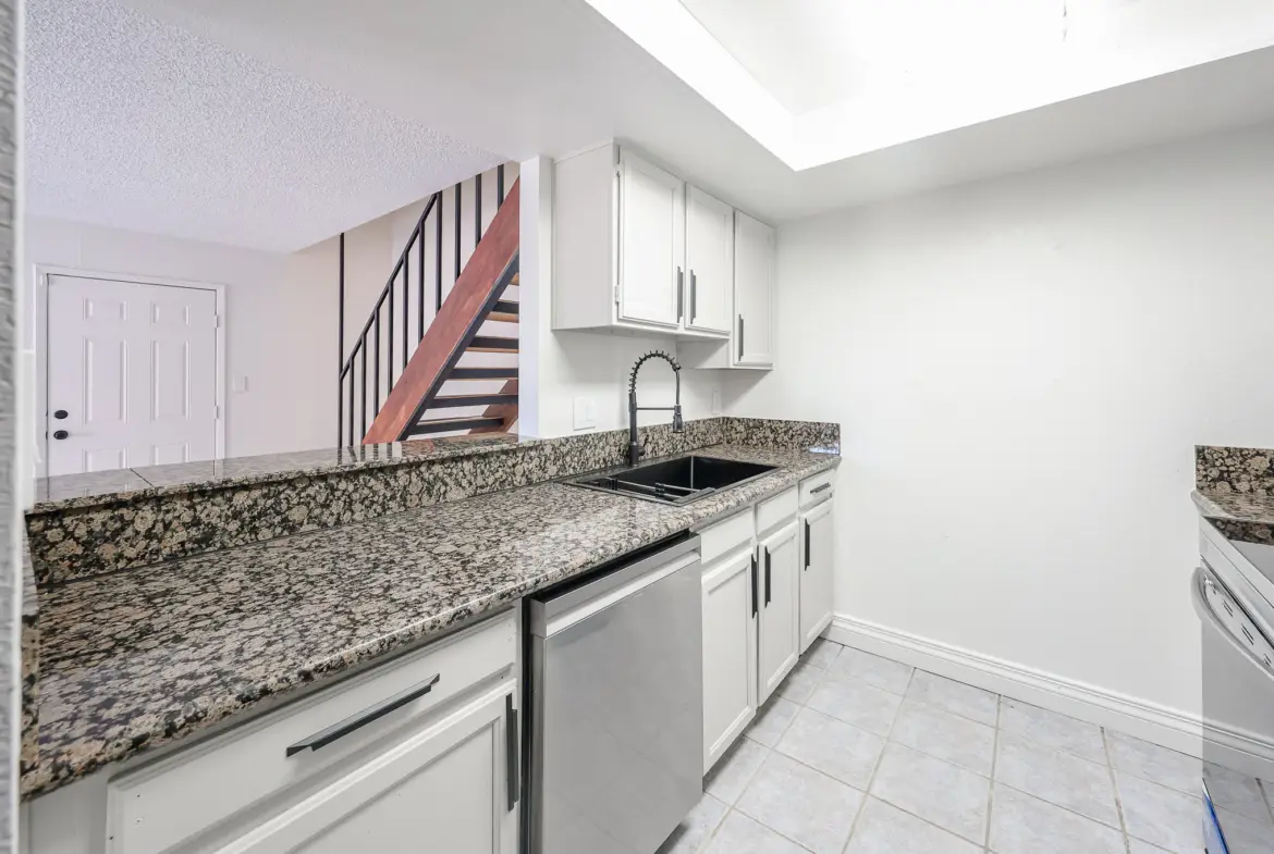 Galley-style kitchen with granite countertops