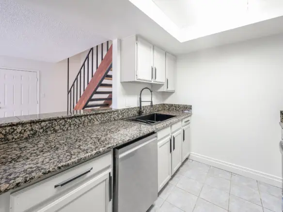 Galley-style kitchen with granite countertops