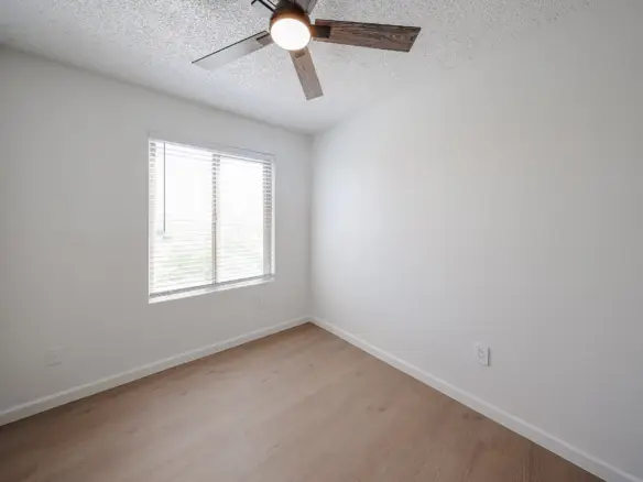 Third upstairs bedroom with window and neutral finishes