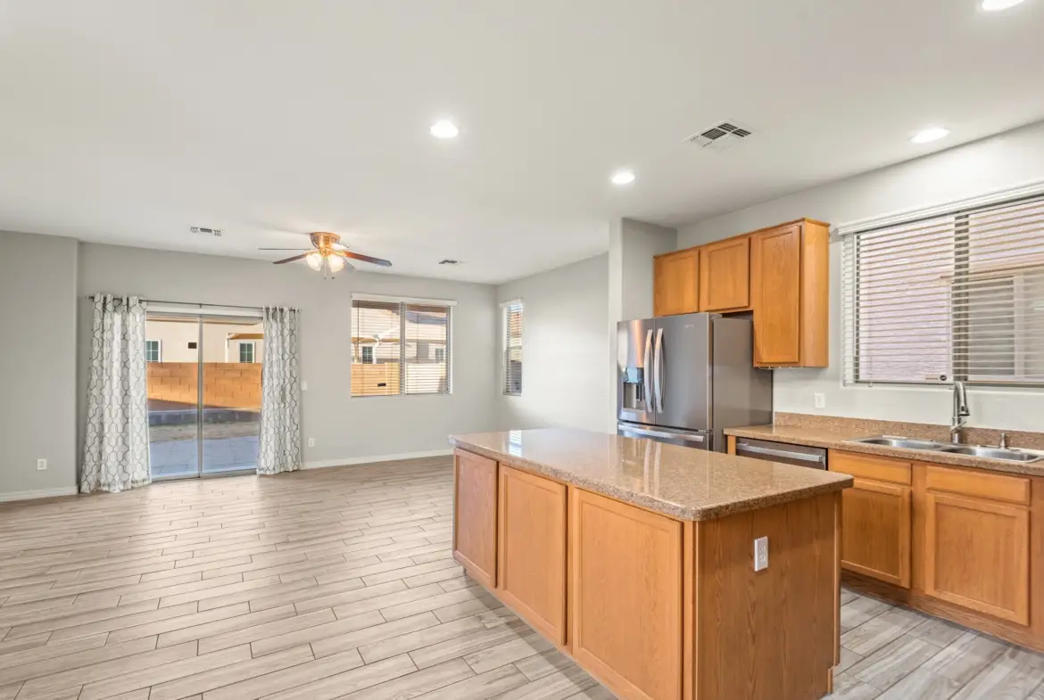 Kitchen to family room at 14772 W Riviera Dr in Surprise, Arizona.