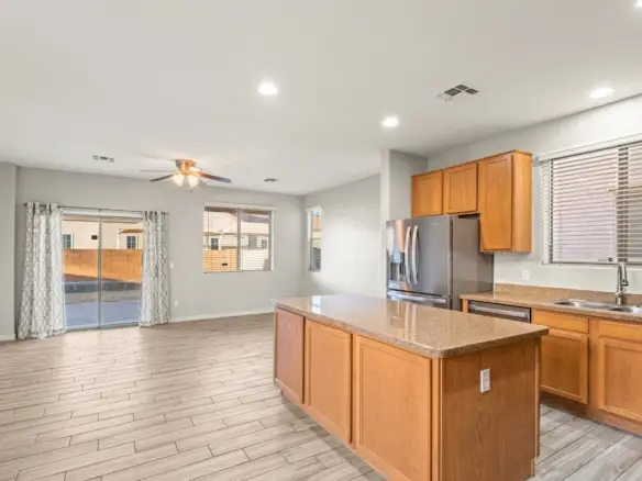 Kitchen to family room at 14772 W Riviera Dr in Surprise, Arizona.