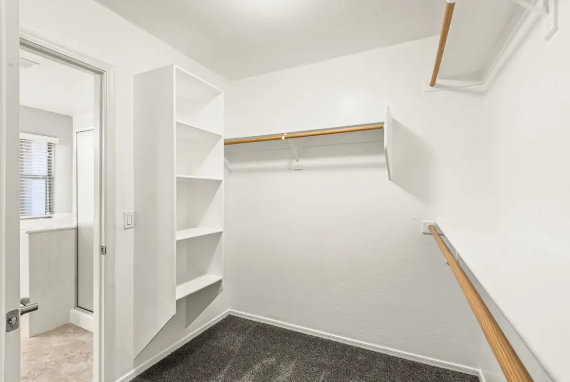 Walk in closet at 14772 W Riviera Dr in Surprise, Arizona.