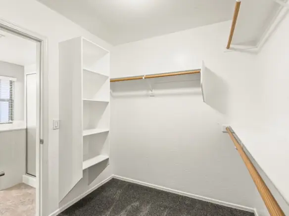 Walk in closet at 14772 W Riviera Dr in Surprise, Arizona.