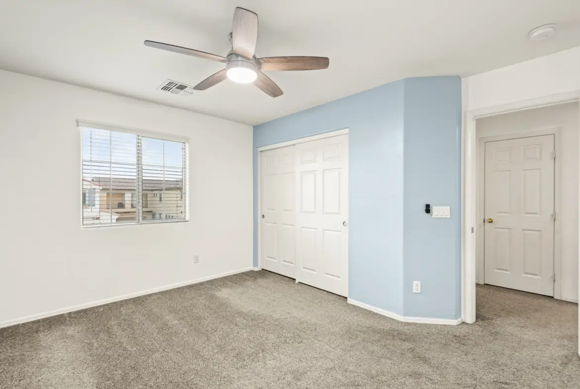 Bedroom two closet at 14772 W Riviera Dr in Surprise, Arizona.
